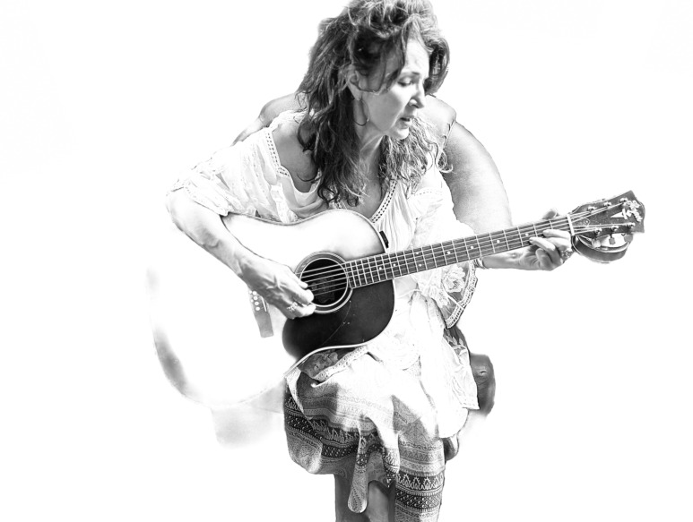 Laurie Kerr close-up holding guitar
