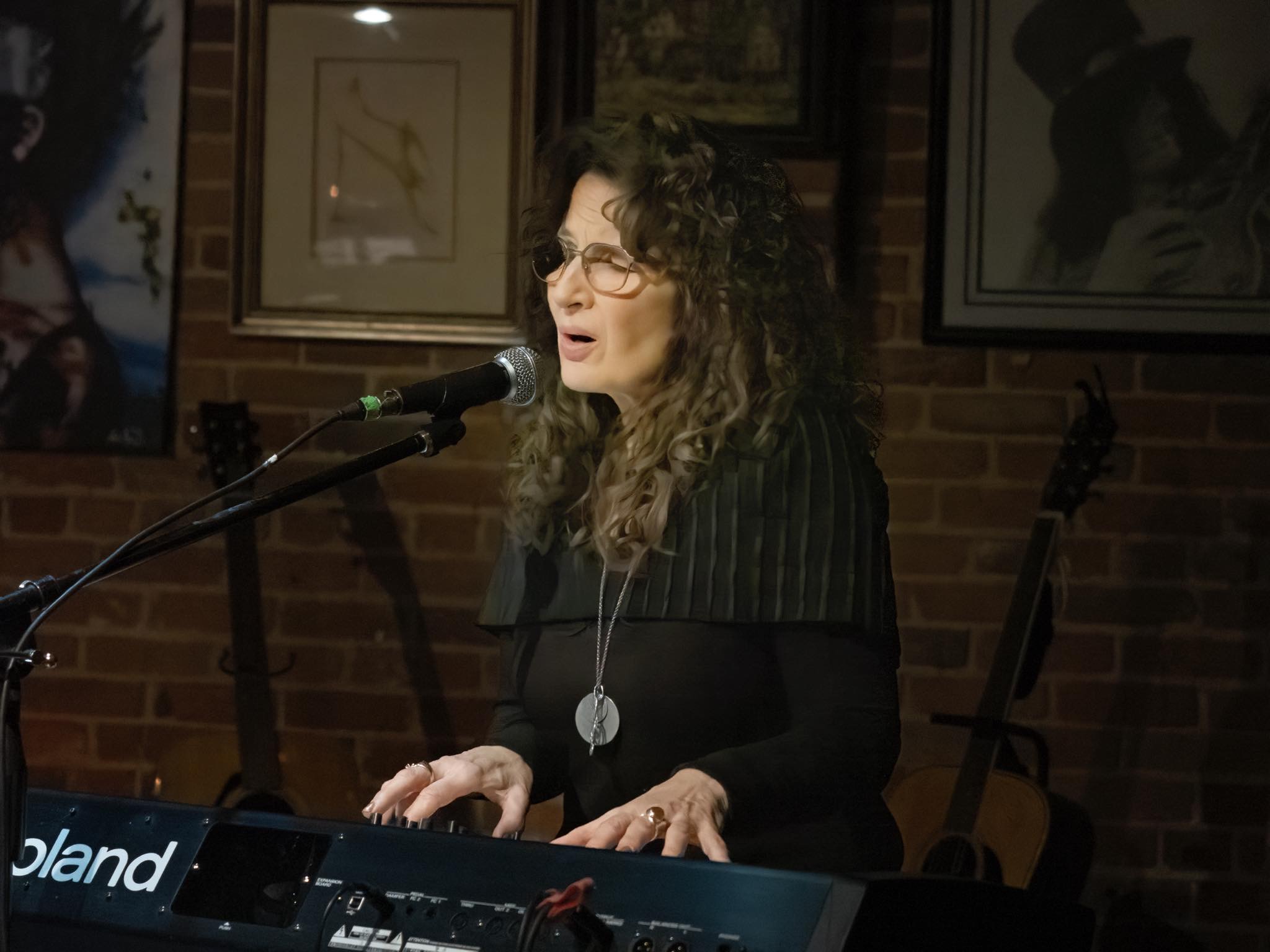 Laurie Kerr behind piano / keys
